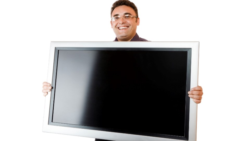 Man holding lcd tv